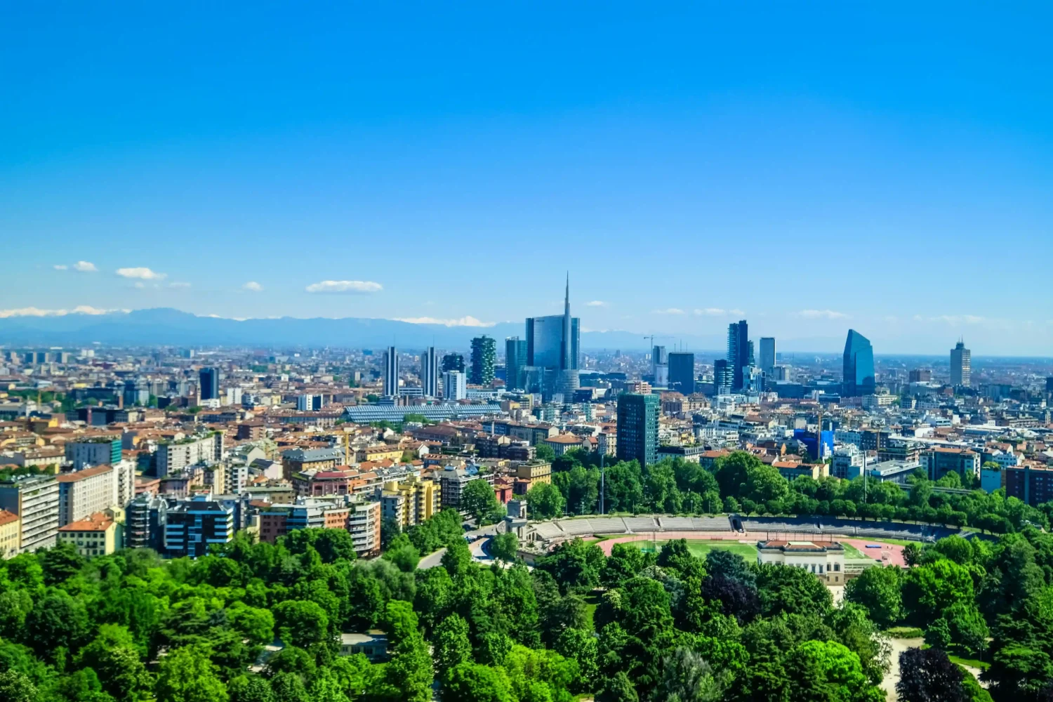 Milan skyline on a bright sunny day with clear blue sky and city buildings visible