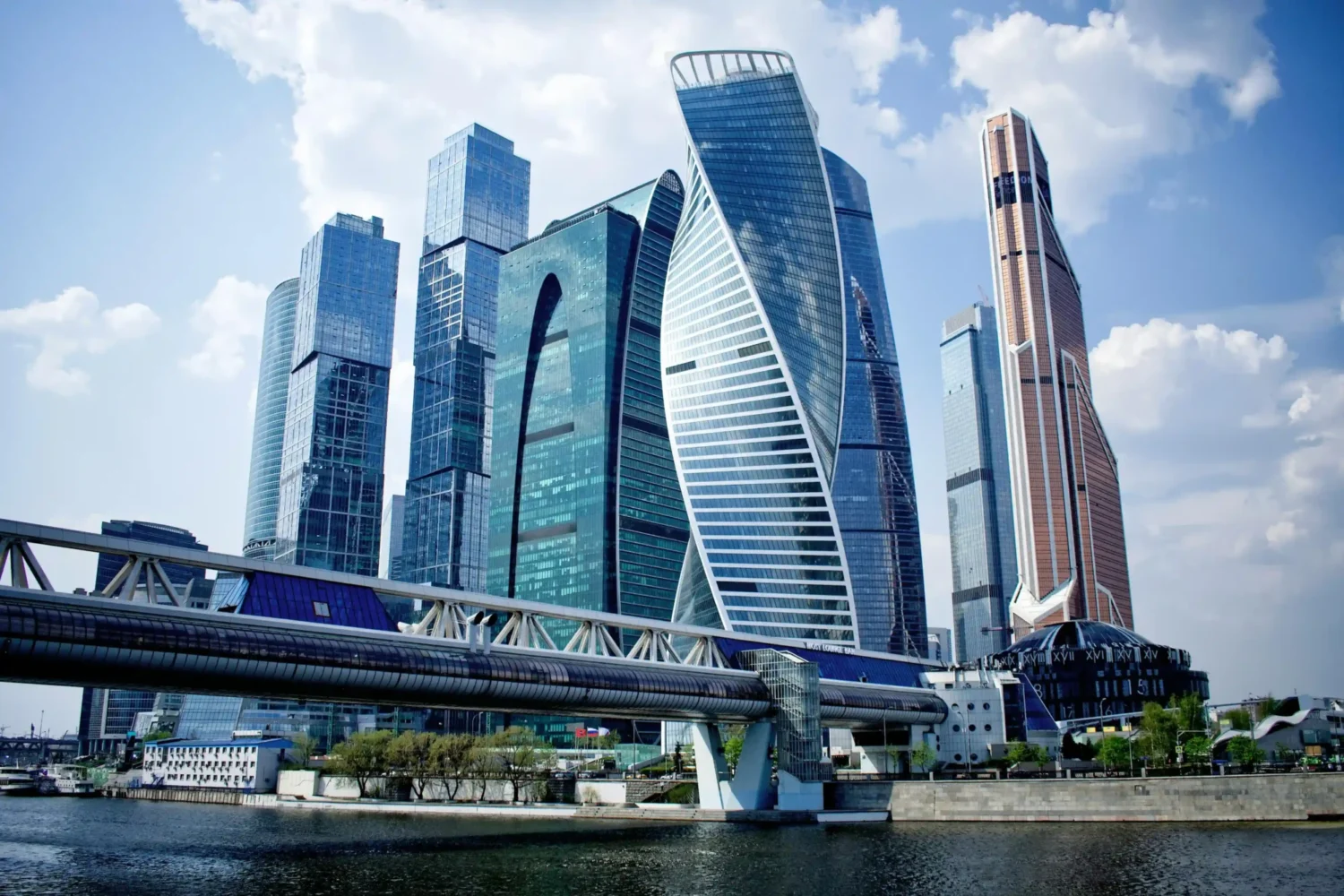 Russian skyscrapers in Moscow at night, showing multiple tall buildings illuminated against the dark sky