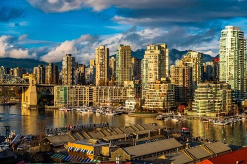 Vancouver skyline viewed from Granville Island with city buildings and waterfront under a bright sky