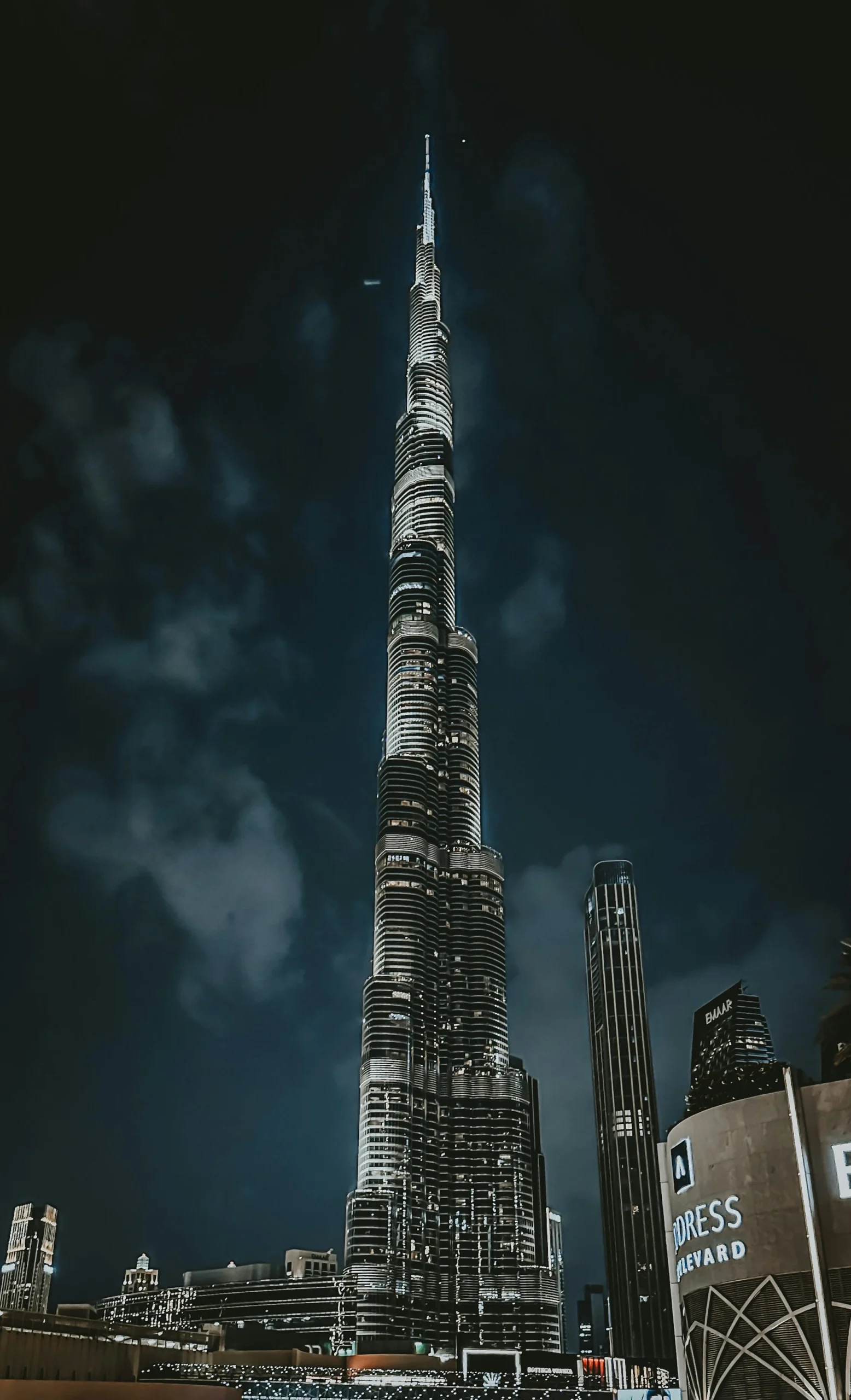 Burj Khalifa Height in Perspective: How Tall is the World's Tallest Building? The Burj Khalifa illuminated at night, showcasing its towering height against the dark sky.