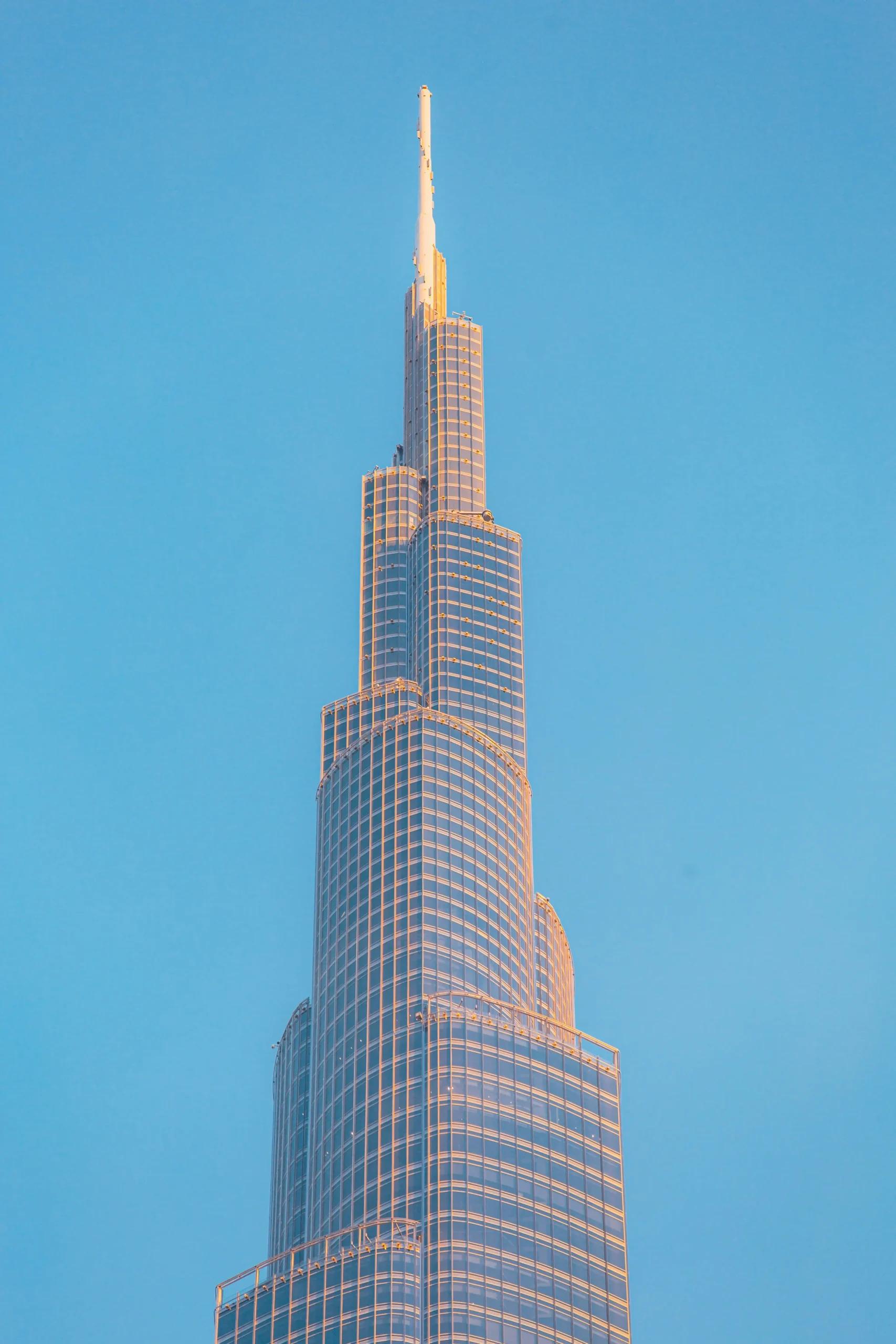 Burj Khalifa Height in Perspective: How Tall is the World's Tallest Building? The Burj Khalifa, the tallest building in the world, showcases its sleek design and towering spire against a clear blue sky.