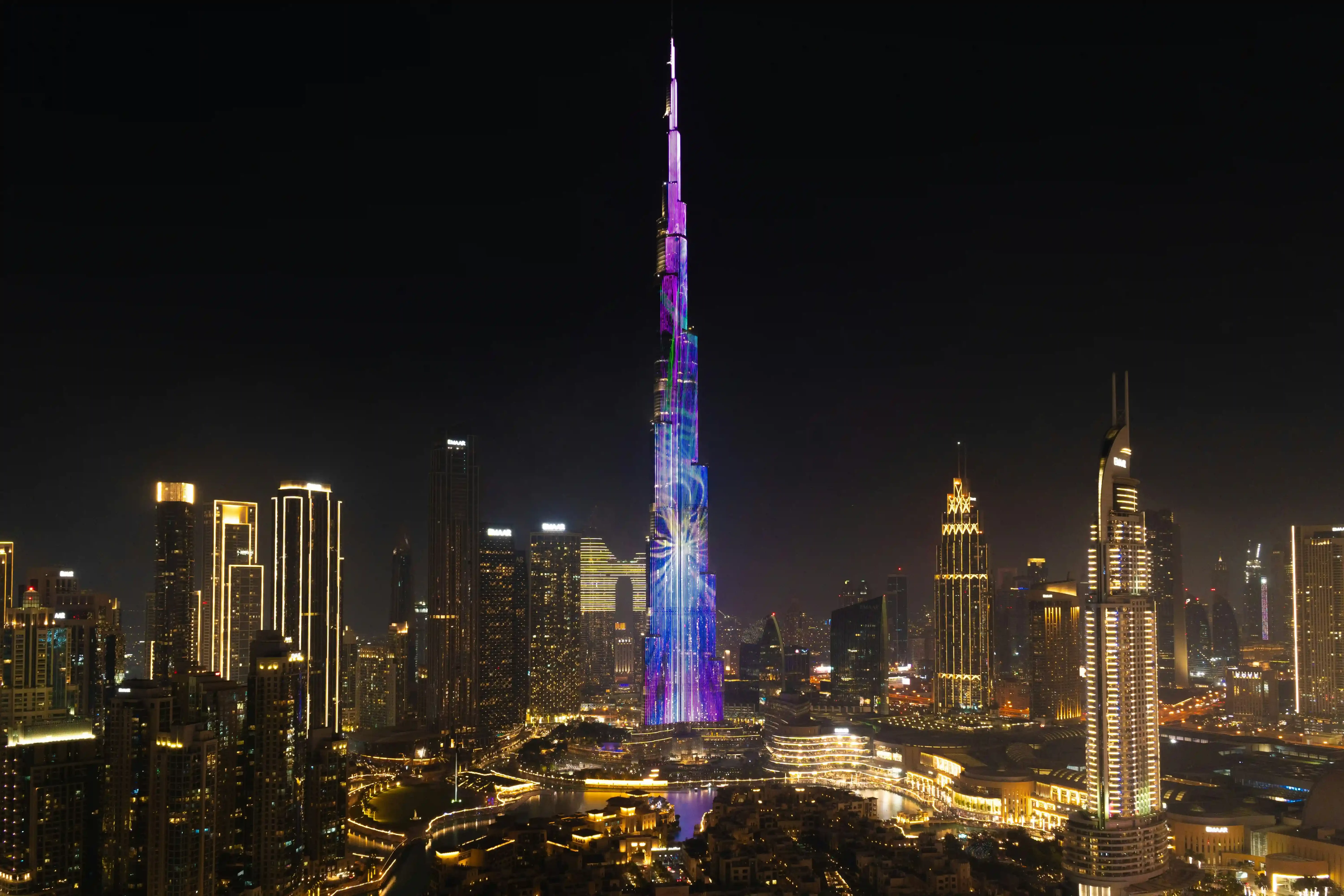 Burj Khalifa Height in Perspective: How Tall is the World's Tallest Building? The Burj Khalifa illuminated at night, showcasing its vibrant colors and architectural design among the skyline of Dubai.