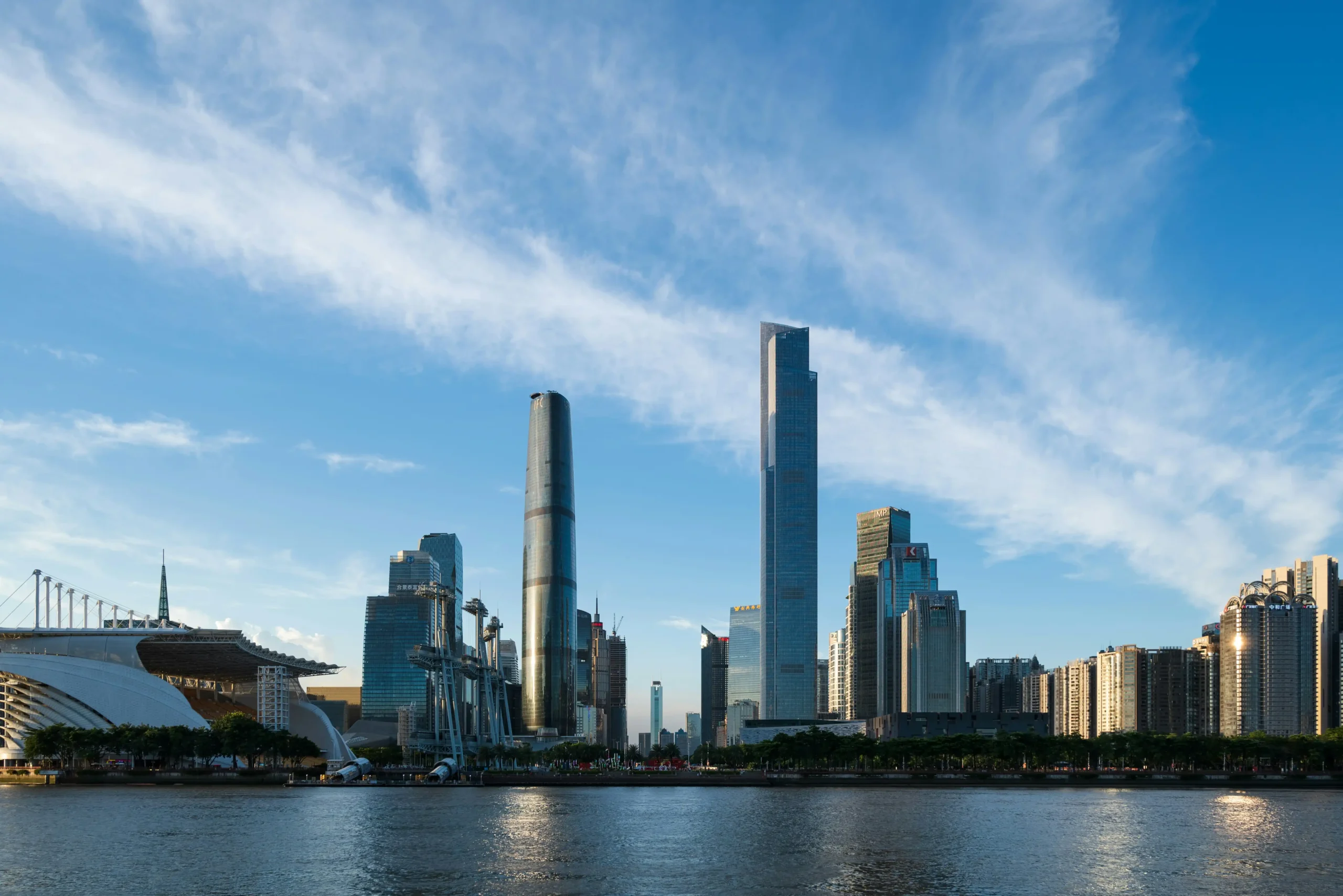 10 Tallest Buildings in the World (2025) Skyline view of Guangzhou, China, featuring several skyscrapers including the Canton Tower and Guangzhou CTF Finance Centre, under a clear blue sky.